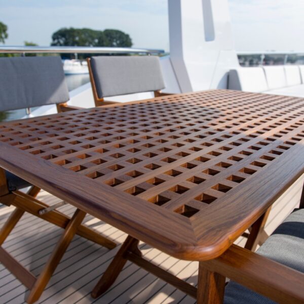 teak table with edge chairs